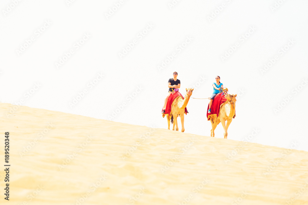Tourists Riding Through The Desert Tourists Riding Through The Desert