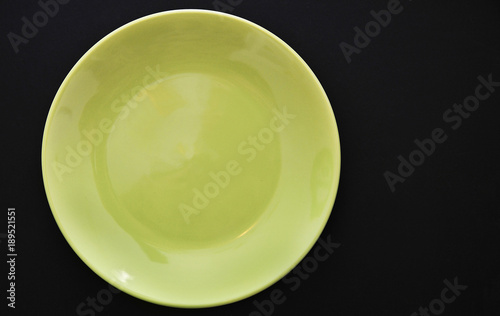 Empty colorful plate on abstract background