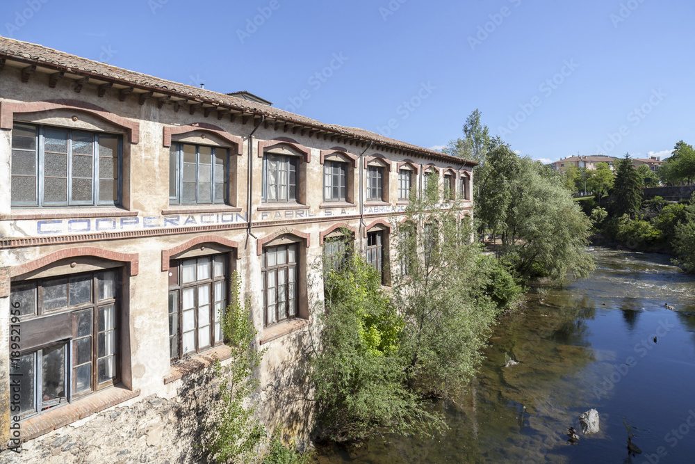 Ancient factory building over river.Olot,Catalonia,Spain.