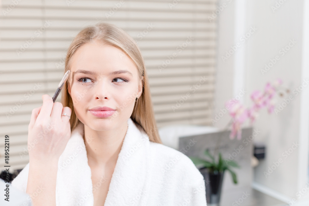 powder base brush. Makeup artist creating beautiful makeup for blondes model. Beauty and Spa centre concept powder base brush. Makeup artist creating beautiful makeup for blondes model. Beauty and Spa centre concept