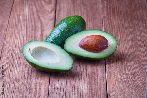 Delicious ripe avocado on a wooden background. Organic food.