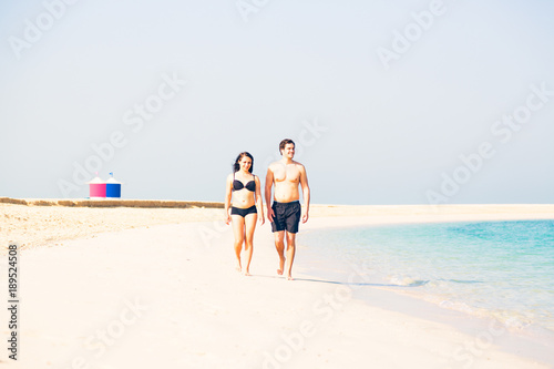 Tourists Walking On The Beach