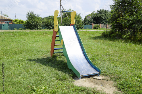 a Children's playground. Swing, carousel and slide photo