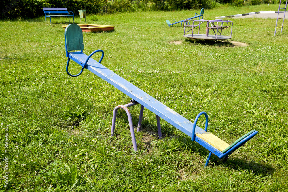 Children's playground. Swing, carousel and slide. Children's rocking chair on the playground. Children's playground. Swing, carousel and slide. Children's rocking chair on the playground.