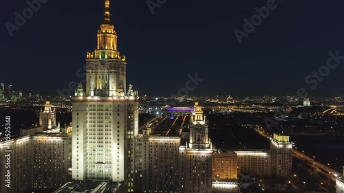 Moscow State University Main Campus and Illuminated Moscow Skyline at Clear Winter Night. Russia. Aerial View. Drone is Flying Forward and Upward. Establishing Shot..