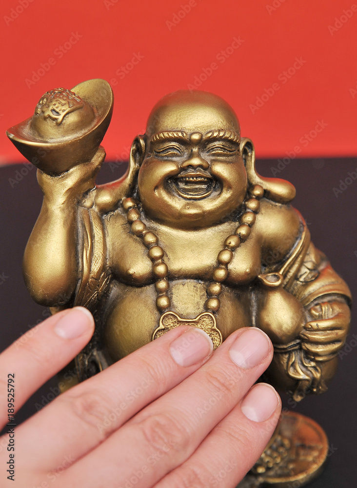 Golden Buddha on a black background 
