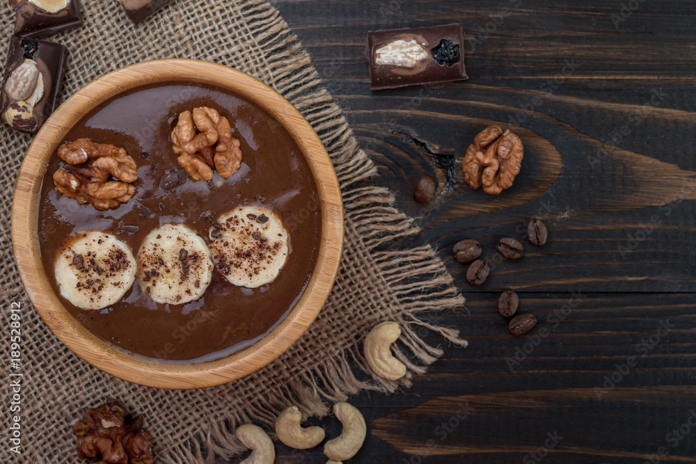 Fresh chocolate  smoothie on a bowl  on wooden  background, top view