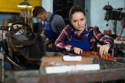  woman worker is working with level