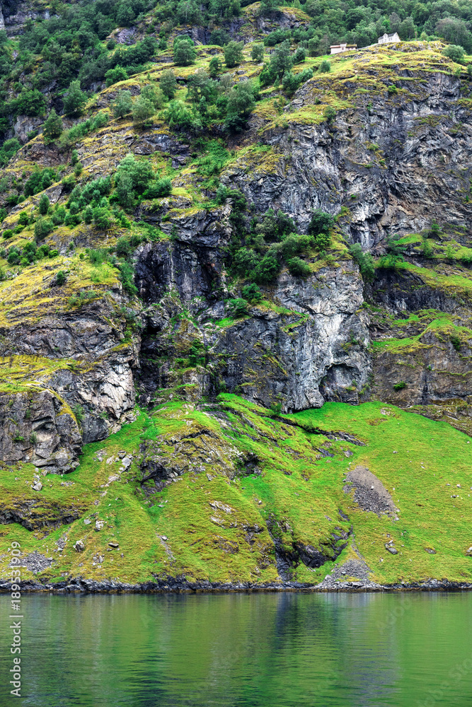 house on a cliff near fjord