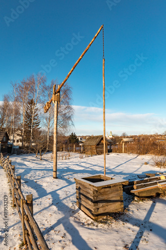 An ancient wooden well in Suzdal in winter. Russia. Suzdal. Golden ring. Rural Russian landscape. photo