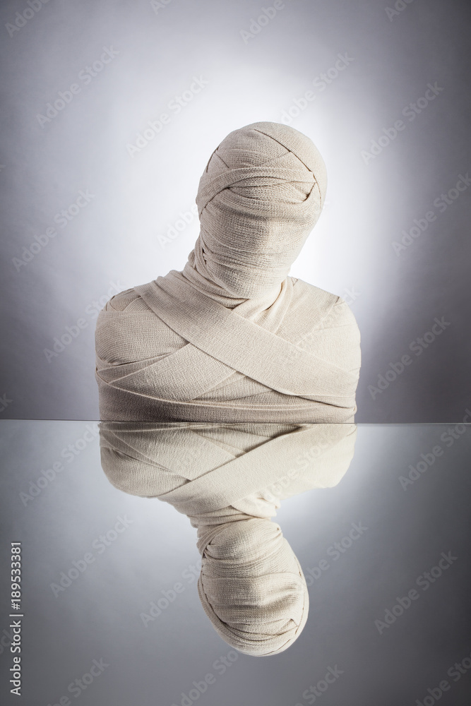 Awakening of mummy. Escape of everyday routine concept. Man wrapped in bandages as egyptian