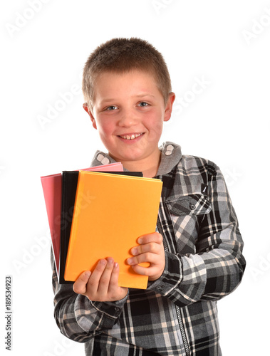 A teenager with books. A boy is studying in a school. A boy's portrait. A cheerful boy. A good mood.