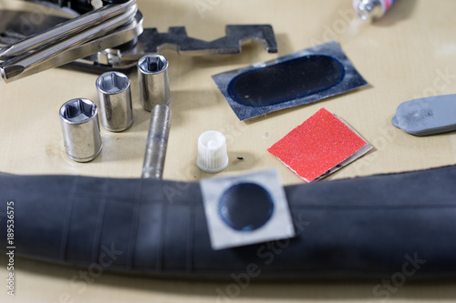 Bicycle breakdown during the trip. Sticking a bicycle tube in a workshop. Mechanic fixing a bicycle tube.