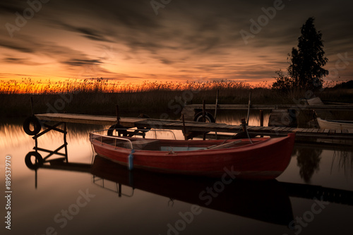 Red boat in sunset