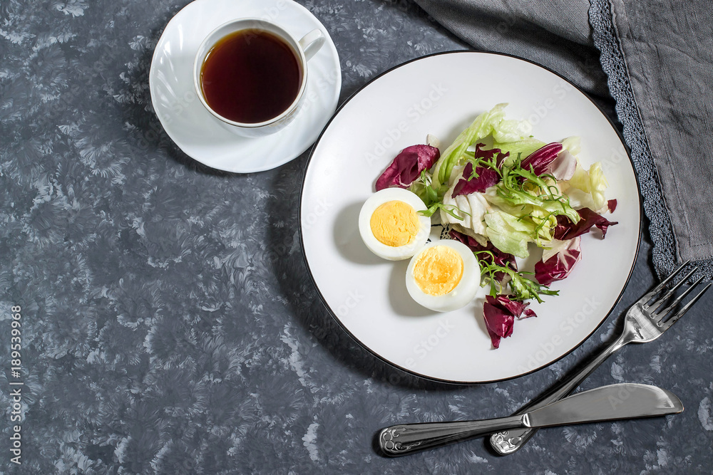 Light breakfast. Boiled eggs, salad mix and cup of coffee Light breakfast. Boiled eggs, salad mix and cup of coffee