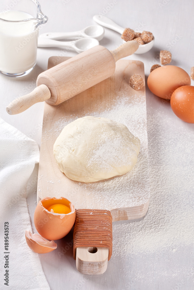 Dough preparation recipe for bread, pizza, pasta, cookies or pie ingridients, food flat lay on kitchen table background. Working with butter, milk, yeast, flour, eggs, sugar pastry or bakery cooking. Dough preparation recipe for bread, pizza, pasta, cookies or pie ingridients, food flat lay on kitchen table background. Working with butter, milk, yeast, flour, eggs, sugar pastry or bakery cooking.