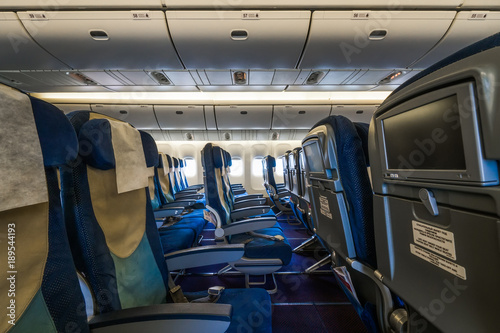 Economy class cabin in a large civil widebody airplane.