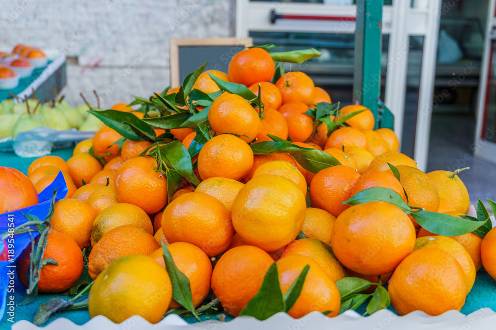 heap of fresh ripe oranges tangerines on the market