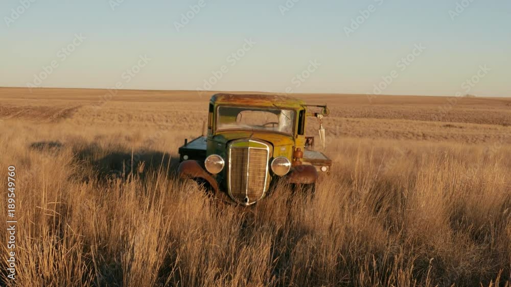 Old abandonded farm truck in windy field medium Old abandonded farm truck in windy field medium