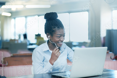 Smiling black female at notebook