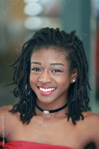 Black female with dreadlocks smiling for camera