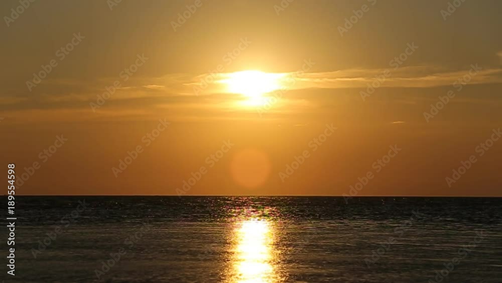 The sun rising over the horizon over the river. The sun rising over the horizon over the river.