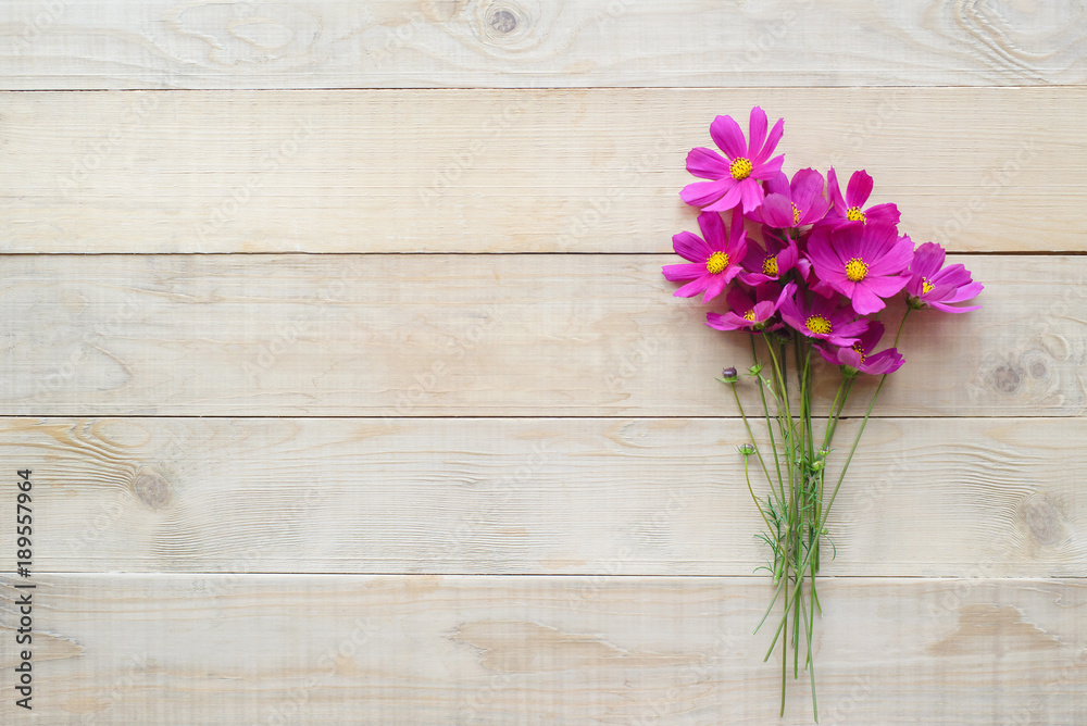 top view of bouquet of cosmos flower on wooden table with copy space