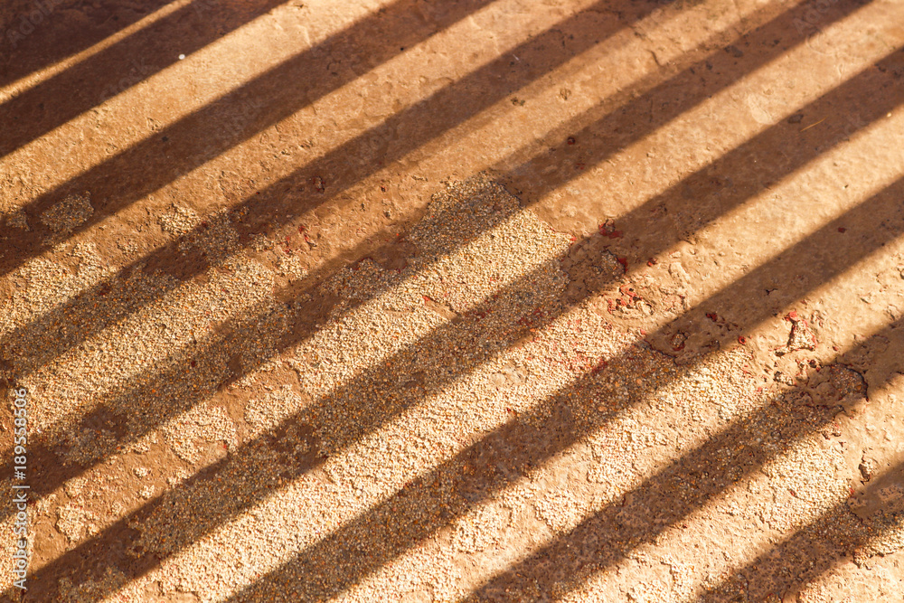 Grunge Background - texured cement with peeling paint and diagonal shadows Grunge Background - texured cement with peeling paint and diagonal shadows