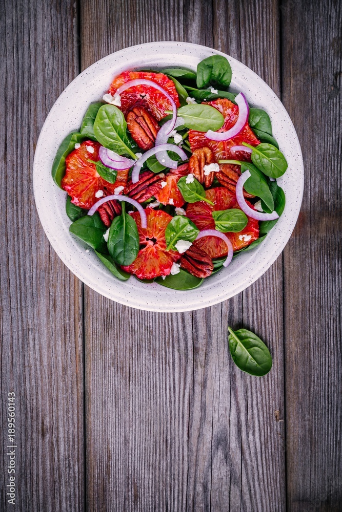spinach salad with feta cheese, blood oranges, red onions and pecan nuts