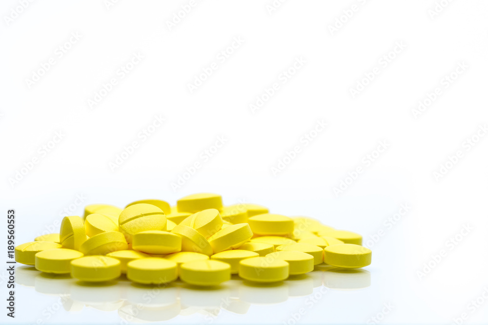 Yellow tablets pills isolated on white background with copy space. Pile of medicine. Painkiller tablets pills. Yellow tablets pills isolated on white background with copy space. Pile of medicine. Painkiller tablets pills.