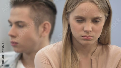 Emotionally immature high-school couple sulking, crisis in relations, conflict