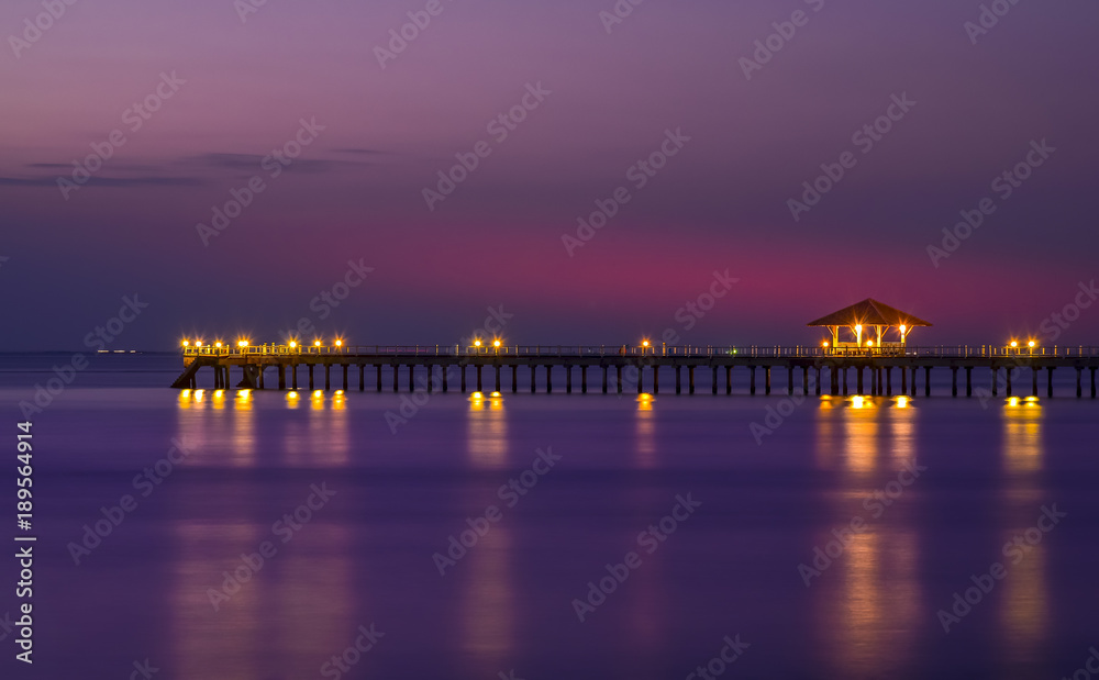 A long beautiful bridge with light of city at twilight time