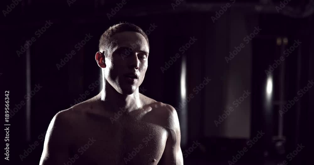 Kickboxer tired after strength training exercise at gym. Tired man after training. Eoung boxer tired after strength training exercise at gym. Exhausted fighter