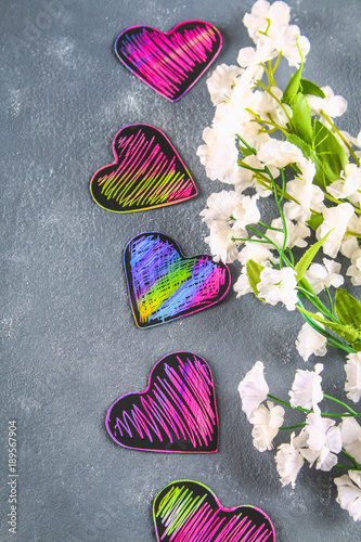 Fototapeta Naklejka Na Ścianę i Meble -  Homemade Black violet pink hearts on a gray concrete background. The concept of Valentine's Day. A symbol of love.