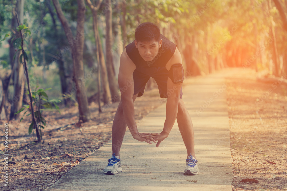 handsome man doing exercises and warm up before run and Physical fitness test ; Healthy lifestyle cardio together at outdoors summer . handsome man doing exercises and warm up before run and Physical fitness test ; Healthy lifestyle cardio together at outdoors summer .