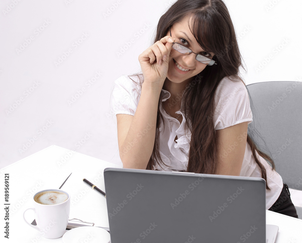 closeup.smiling business woman sitting at a Desk. closeup.smiling business woman sitting at a Desk.