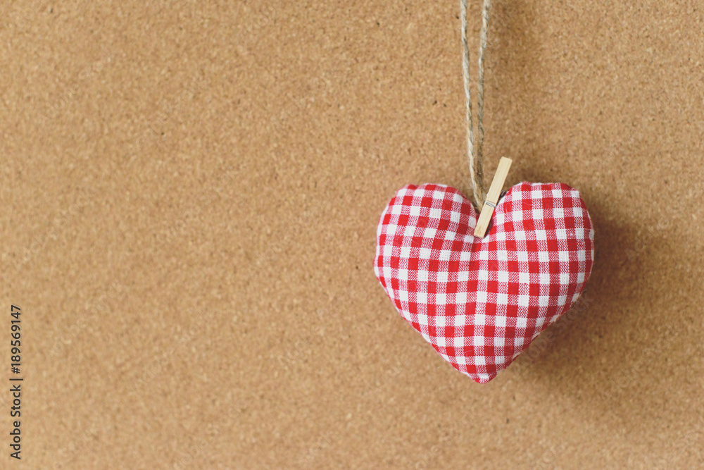 Red textile heart over brown craft recycle cork board background. Free copy space. Valentine's day concept. Red textile heart over brown craft recycle cork board background. Free copy space. Valentine's day concept.