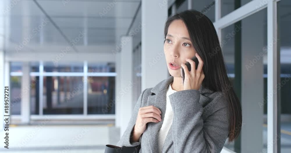 Businesswoman talk to mobile phone at outdoor Businesswoman talk to mobile phone at outdoor