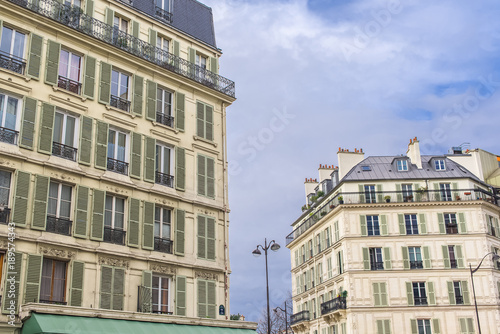 Paris, beautiful building facades in a attractive area of the capital, green shutters
