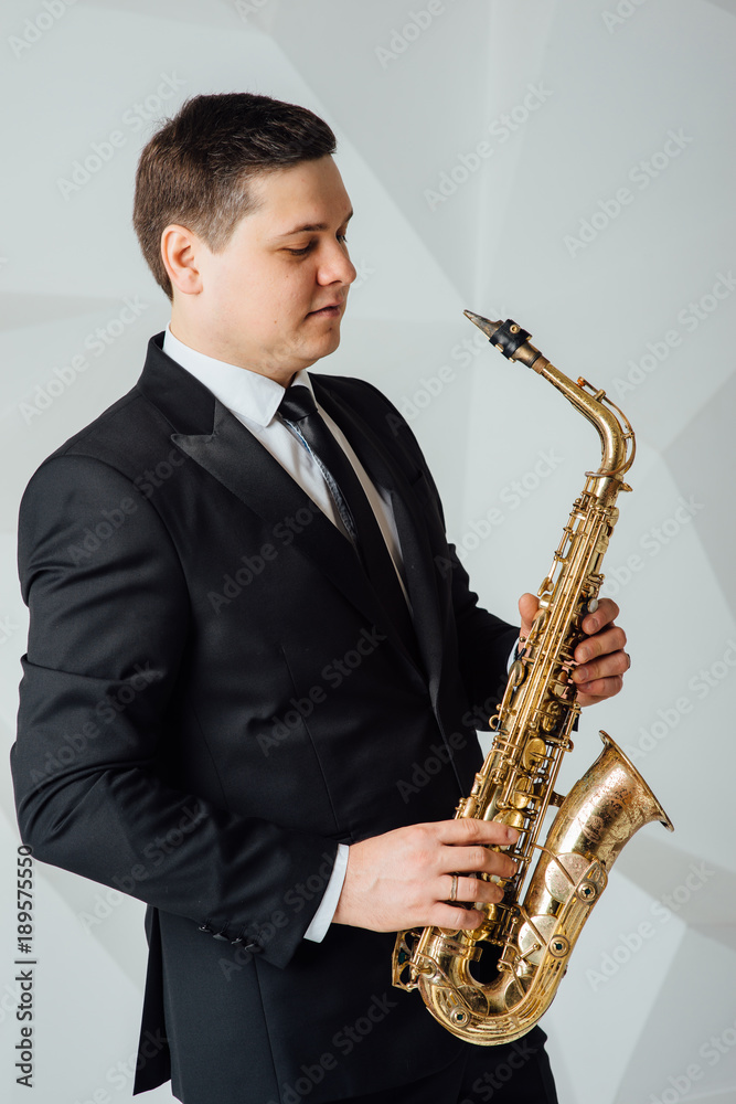 Fototapeta premium A man plays the saxophone close up