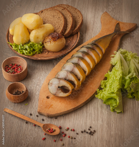 Mackerel smoked and grilled vegetables, salad on a cutting board