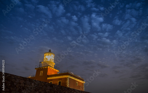 Faro di Capo Spartivento con lampada accesa di notte photo