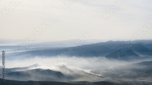 scenic view of mountains in fog and sky