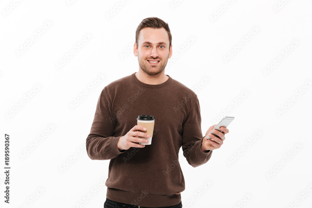 Cheerful young man drinking coffee and chatting Cheerful young man drinking coffee and chatting