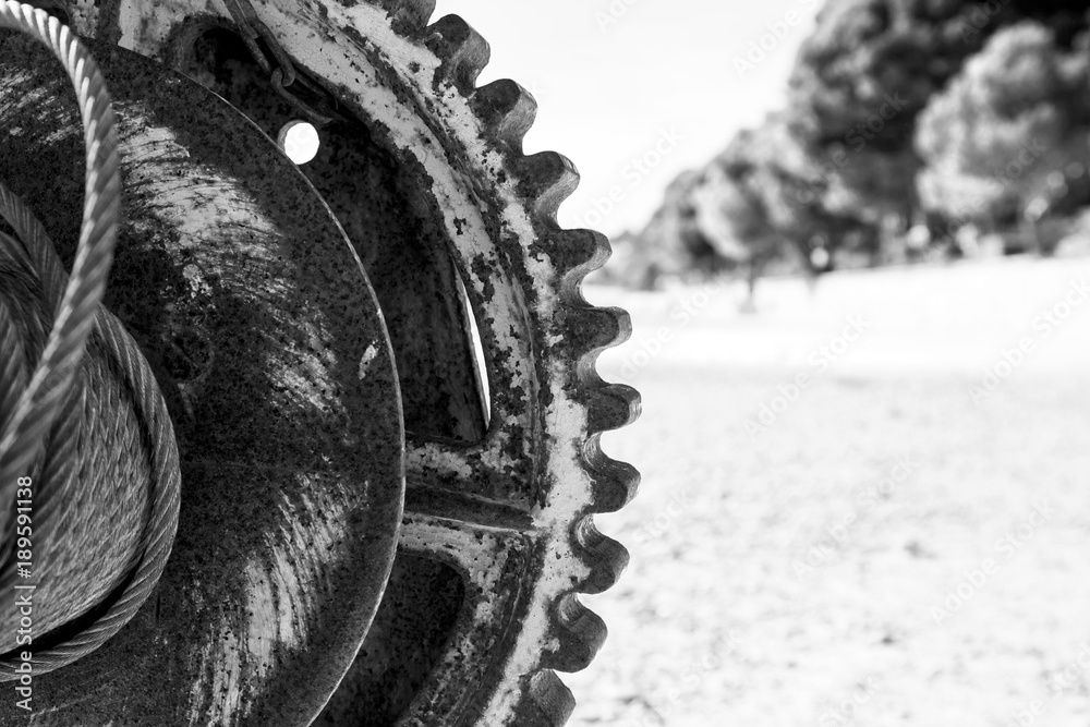 black and white picture of a rusted mechanism with a pinion and a nut black and white picture of a rusted mechanism with a pinion and a nut