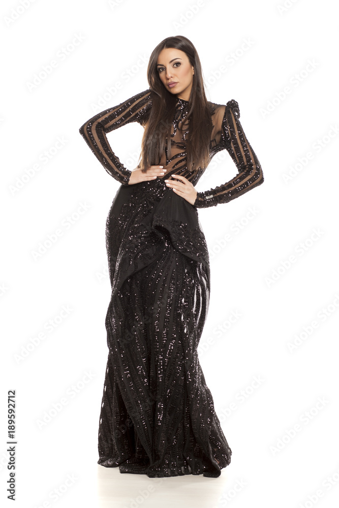 young beautiful woman in a black evening dress on a white background young beautiful woman in a black evening dress on a white background