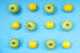 Top view of colorful fruit pattern of fresh lemon and apple on blue background