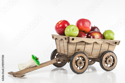 A wooden cart with apples. ...