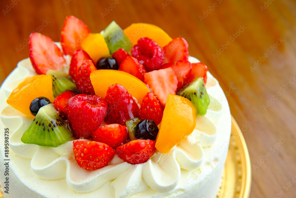 Cake with exotic fruits over wooden background Cake with exotic fruits over wooden background