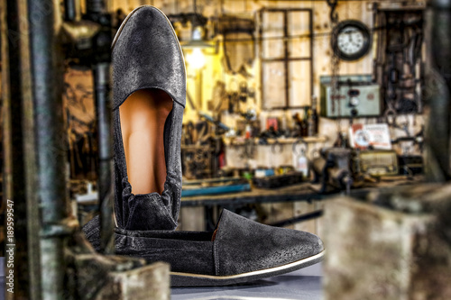 woman handmade shoes and workspace background 